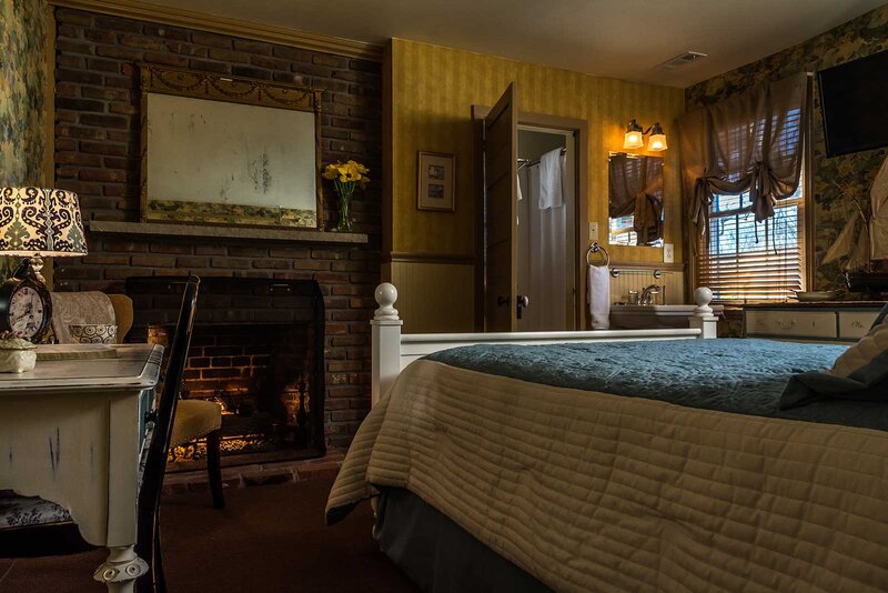 Abbott bedroom with bed and fireplace